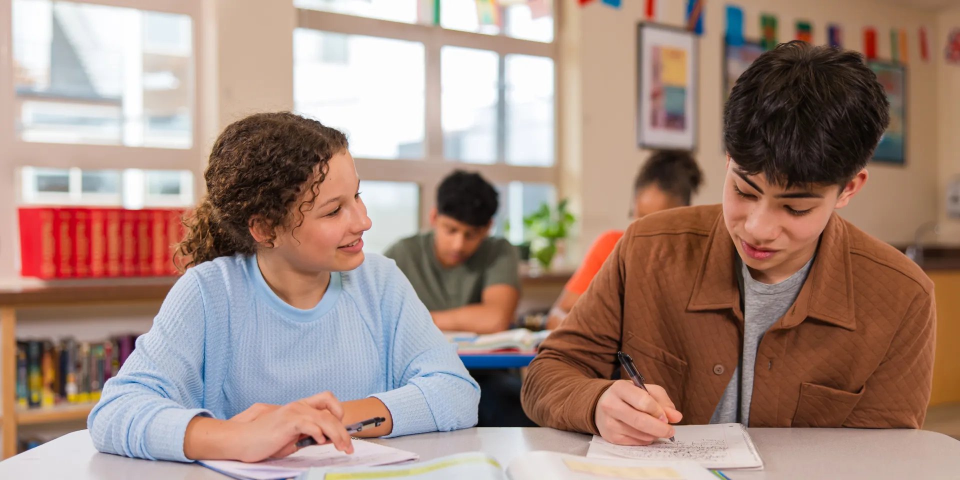 A photo of two students working on an assignment together