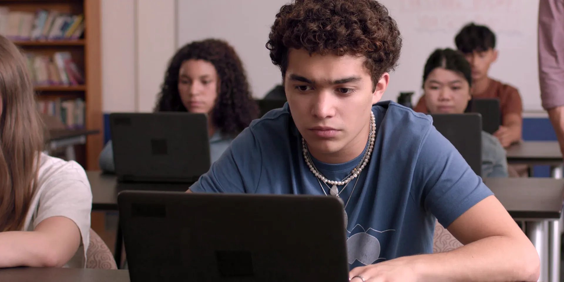 Miguel taking benchmark assessment on a laptop