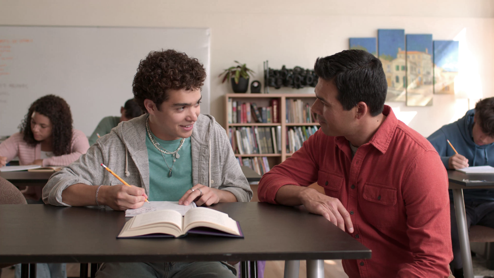 Teacher helps a student